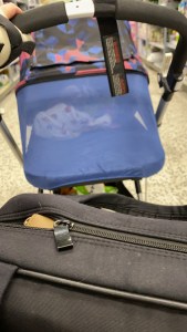 A photo of a black Bugaboo Cameleon 3 Plus Pushchair with a multicoloured Breezy hood on. The hood has the blue built in mosquito net deployed. 